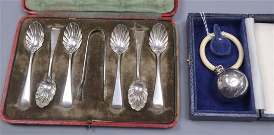A cased set of George V silver teaspoons and tongs and a cased modern silver childs rattle.